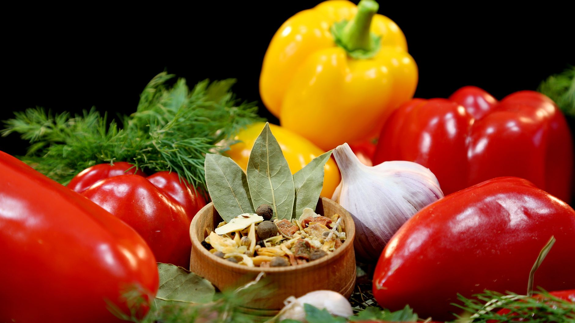 A vibrant assortment of peppers, herbs, and spices, ideal for culinary themes.